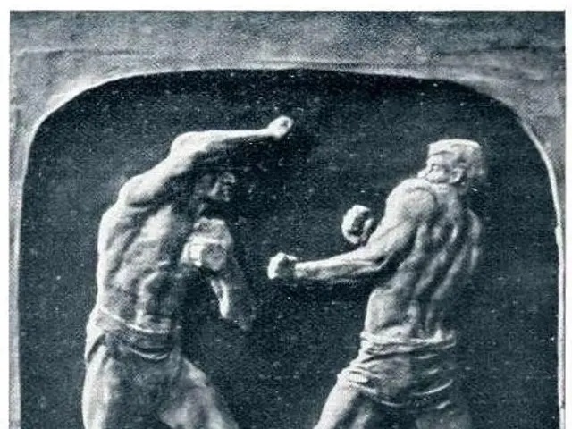 The image shows a black and white photo of two men in a boxing ring, engaged in a sparring match....