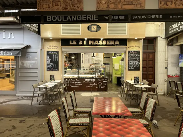 The image shows a restaurant with tables and chairs in front of it, located in Paris, France. The...