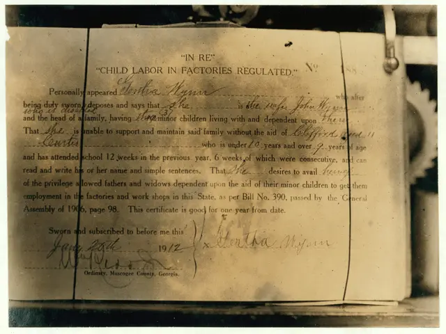 The image shows an old black and white photo of a document with text written on it, which appears...