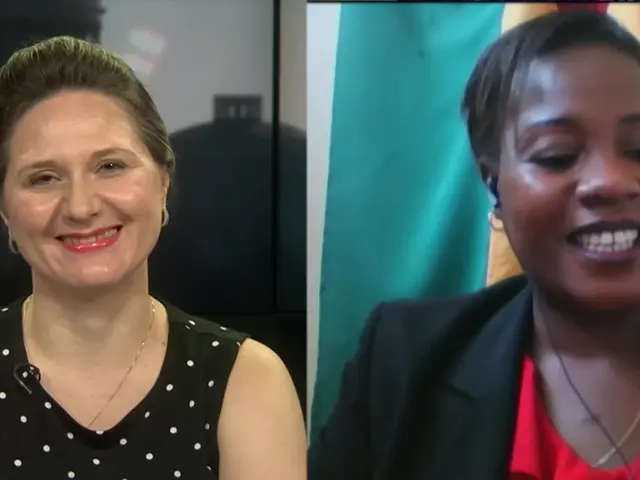 The image shows two women sitting next to each other on a video call, both with smiles on their...