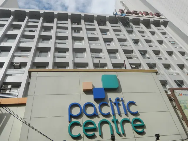 The image shows the Pacific Centre Hotel in Manila, Philippines. It is a tall building with...