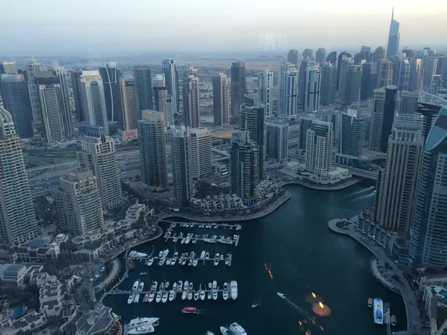 The image shows a stunning view of the Dubai Marina from the top of the Burj Khalifa Tower. The...