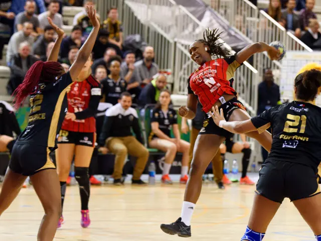 The image shows a group of women playing a game of volleyball on a court, with a ball in the...