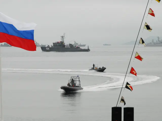 The image shows a group of boats traveling across a body of water, with a Russian flag flying in...