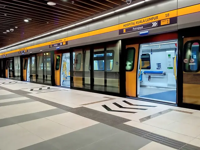 The image shows a train at a station with a platform and a train on it. The train is on the railway...