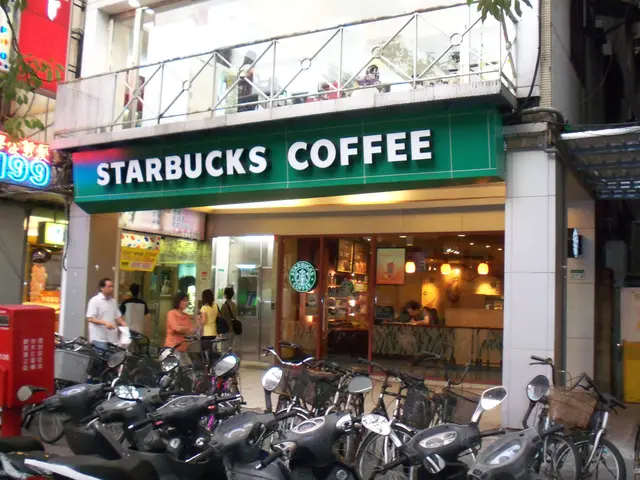 The image shows a Starbucks coffee shop in Hong Kong, with a number of motorcycles parked in front...