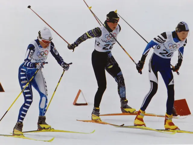 The image shows three skiers racing down a snowy slope, each holding a ski pole in their hands....