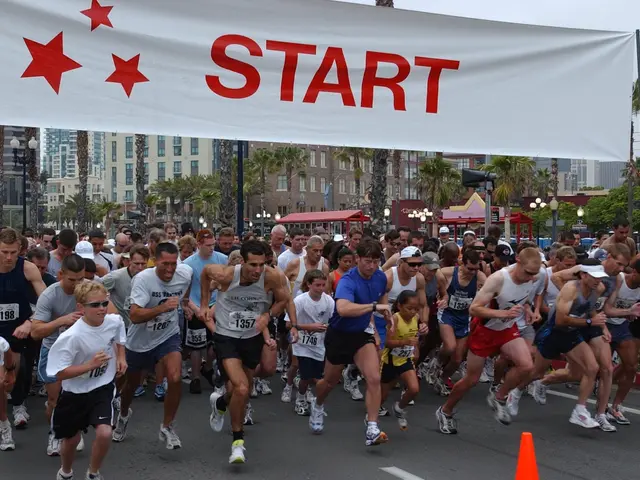 The image shows a group of people running in a marathon, with a traffic cone in the foreground and...