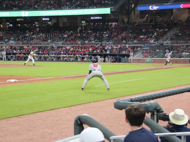 The image shows a baseball game being played in a stadium, with a group of people playing on the...