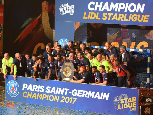 The image shows a group of Paris Saint-Germain players celebrating with the trophy after winning...