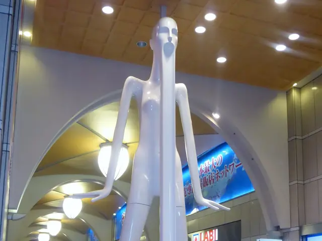 The image shows a large white statue of a man standing in the middle of an airport, surrounded by a...