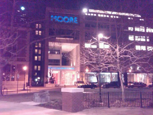 In the image there is a building, it looks like some hospital and in front of the building there...