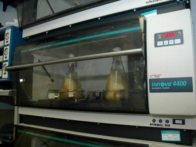 The image shows a laboratory with a machine sitting on top of a counter, surrounded by other...
