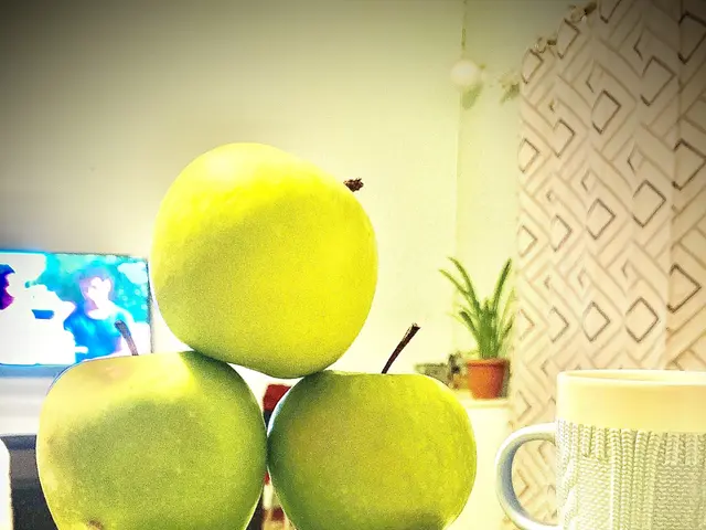 The image shows a white plate topped with green apples next to a cup of coffee. In the background,...
