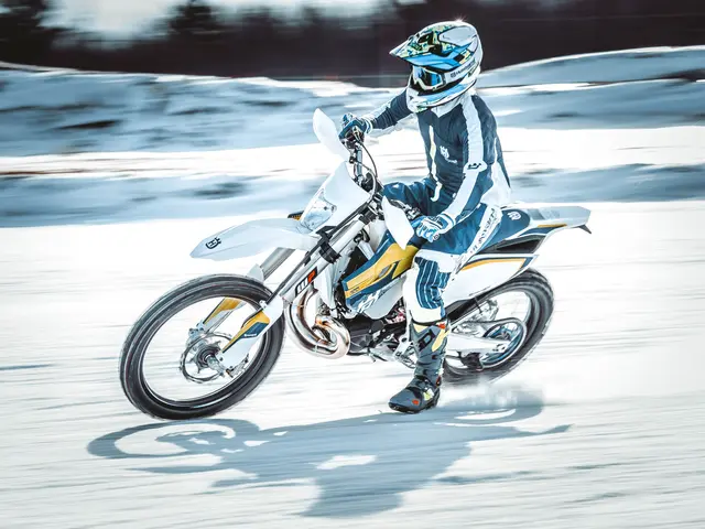 The image shows a person wearing a helmet, gloves, and shoes riding a 2017 Husqvarna FE 501...