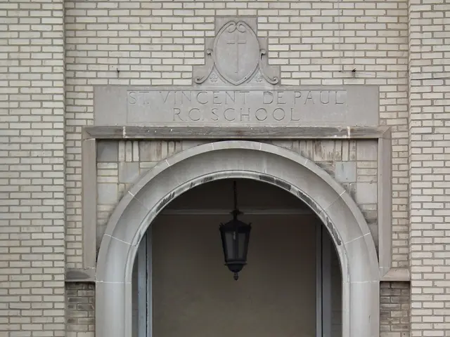 The image shows the entrance to a brick building with a yellow caution tape around it. At the...