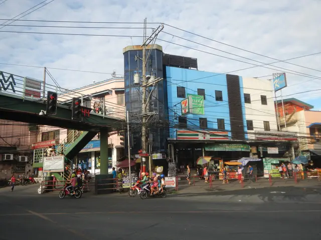 The image shows a bustling city street in Manila, Philippines, with people walking and riding...