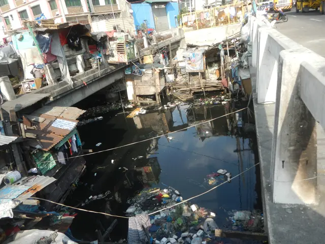 The image shows a river running through a city filled with lots of trash, with a bridge on the...