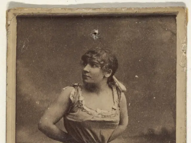The image shows an old photo of a woman in a bathing suit standing on a beach, with text at the...