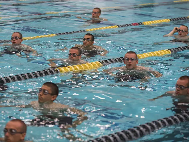 The image shows a group of swimmers in a swimming pool, wearing goggles and surrounded by lane...