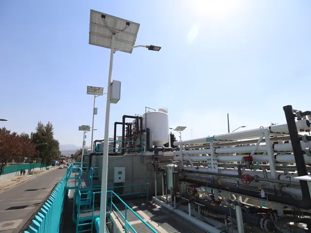 The image shows a large building with a lot of pipes and solar panels on top of it, surrounded by...