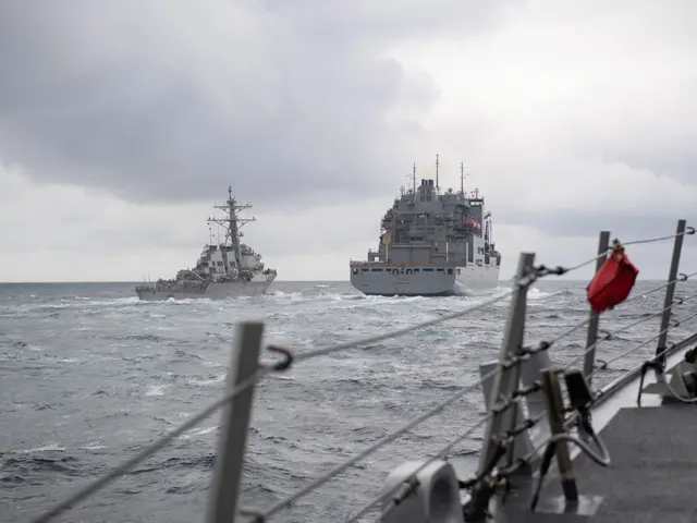 The image shows two ships in the ocean with a cloudy sky in the background. On the right side of...
