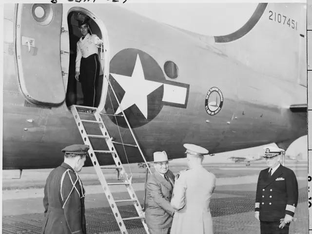 The image shows a group of men standing on top of an airplane, with a woman standing on the steps...