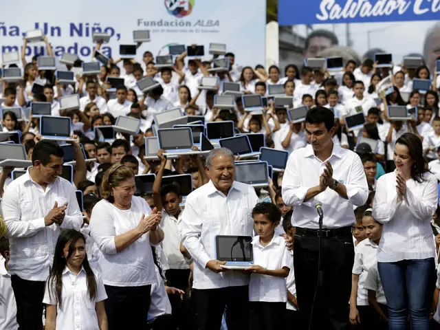 The image shows a group of people standing in front of a crowd of people, some of whom are clapping...