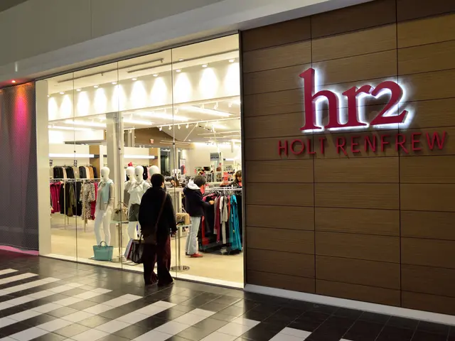 The image shows a holt renfrew store in a shopping mall, with a group of people standing on the...