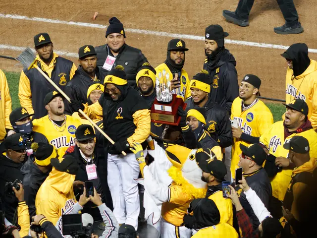 The image shows a group of baseball players standing on top of a field, wearing yellow and black...