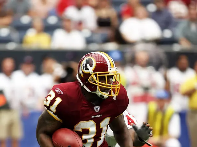 The image shows Washington Redskins running back Robert Griffin III running with the ball during a...