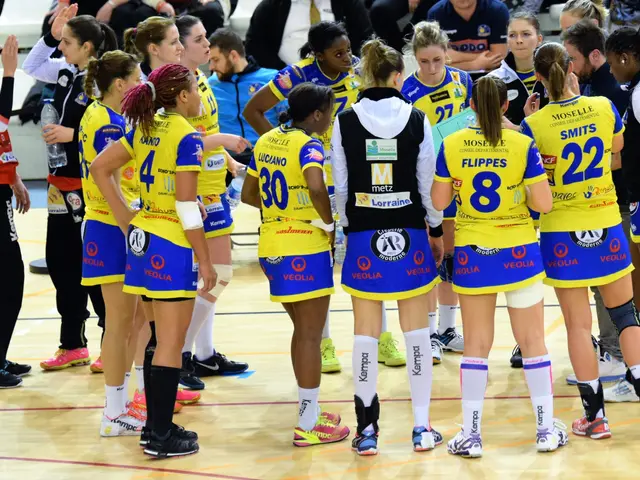The image shows a group of women standing on top of a basketball court, with some of them holding...