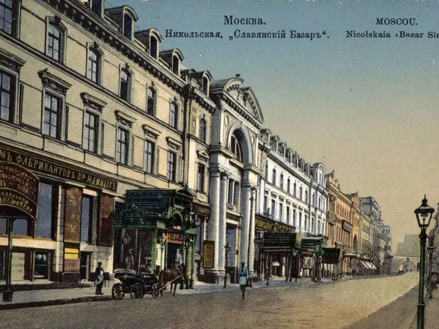 The image shows an old postcard of a city street in Moscow, Russia. We can see buildings, street...