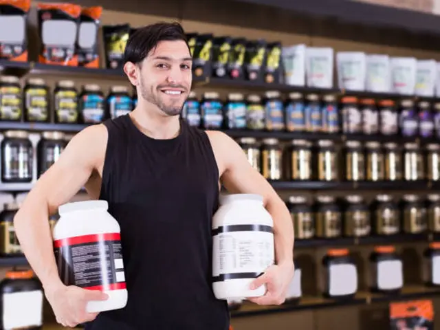 The image shows a man standing in front of a shelf filled with bottles of supplements, holding two...