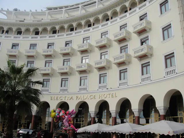 The image shows the Electra Palace Hotel in Macau, China. It is a large building with windows,...