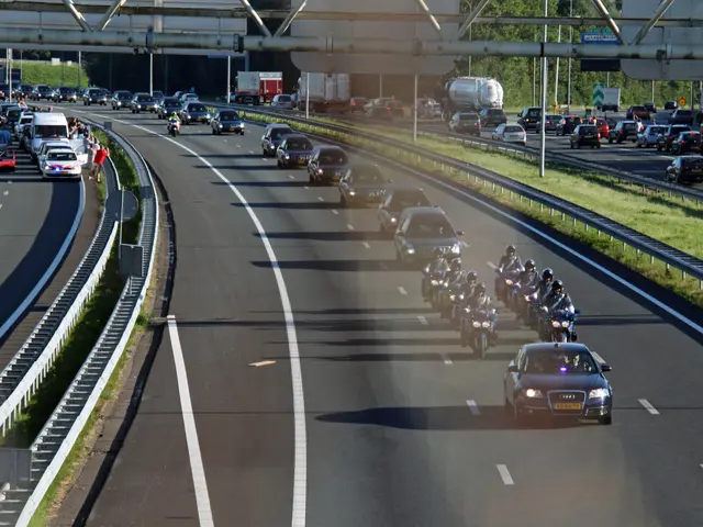 The image shows a highway filled with lots of traffic, including cars and motorcycles. There are...