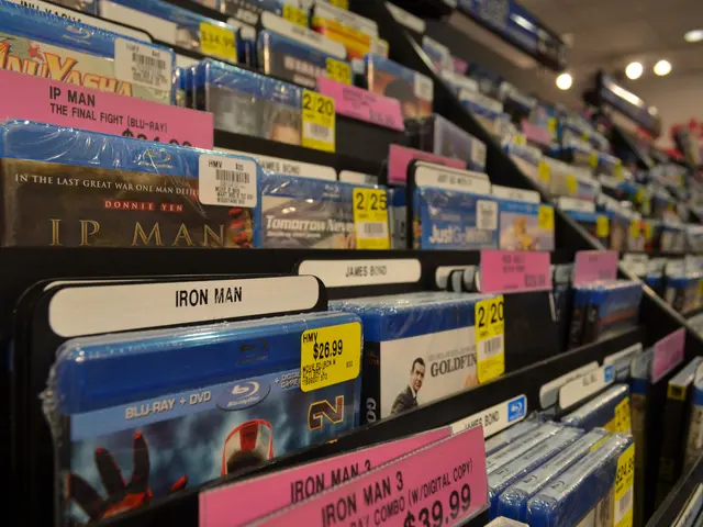 The image shows a store shelf filled with lots of different types of DVDs, each with a price tag...