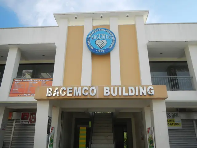 The image shows the Bacemco Building in Manila, Philippines. It is a building with pillars,...