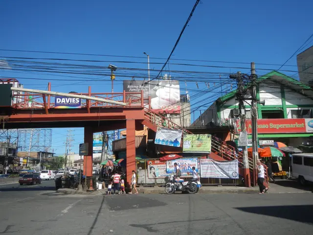 The image shows a bustling city street with a bridge over it. There are vehicles on the road,...