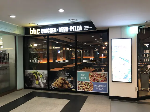 The image shows a bhc chicken & beer pizza restaurant in the middle of a mall. The floor is visible...