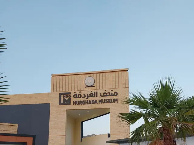 The image shows the entrance to the Hurghada Museum in Abu Dhabi, United Arab Emirates. It features...