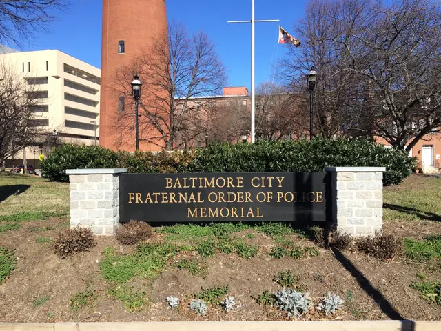 The image shows the Baltimore City Fraternal Order of Police Memorial, with a name board on the...