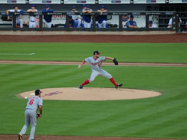 The image shows a baseball player pitching a ball on top of a field, with two people standing on...