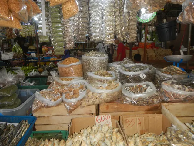 The image shows a market filled with lots of different types of food, including fish in plastic...