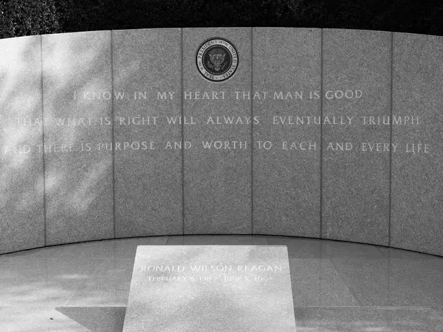 The image shows a black and white photo of the Vietnam Veterans Memorial in Washington, DC. In the...