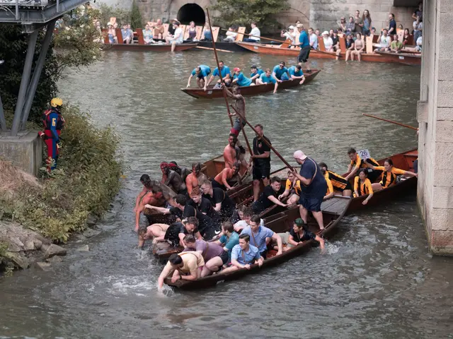 The image shows a group of people in canoes on a river, with some of them holding paddles. On the...