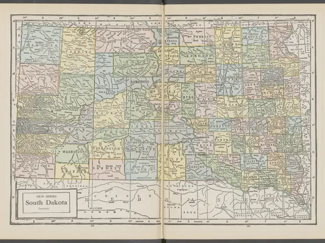 The image shows an open book with a map of South Dakota on it. The map is detailed and shows the...