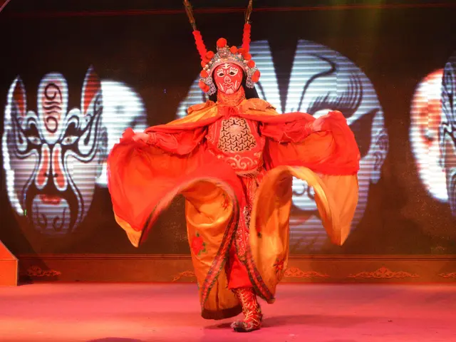 The image shows a woman in a red dress performing a Chinese opera on stage, with a screen in the...