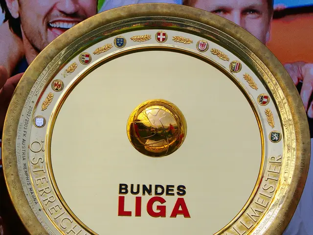The image shows a man holding up a golden shield with the words "Bundesliga" written on it. In the...