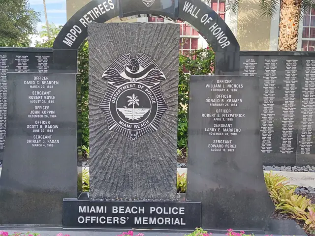 The image shows the Miami Beach Police Officers Memorial, with a memorial stone in the center...
